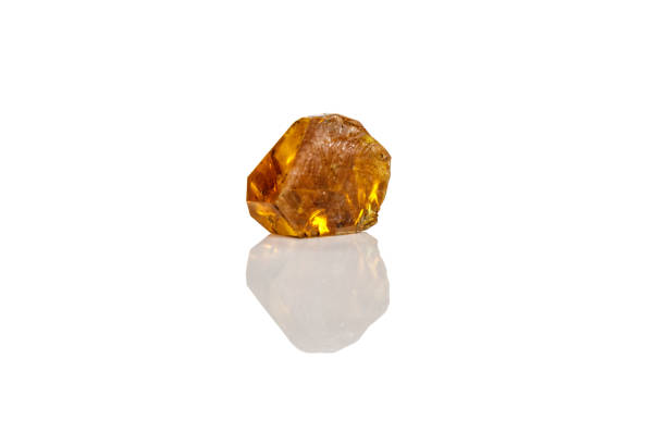 istock Macro yellow diamond mineral stone on white background 1151244605