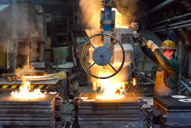 istock workers in a foundry casting a metal workpiece - safety at work and teamwork 1151244824