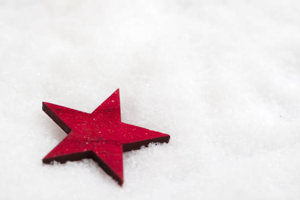 istock wooden red star in the snow 1151244856