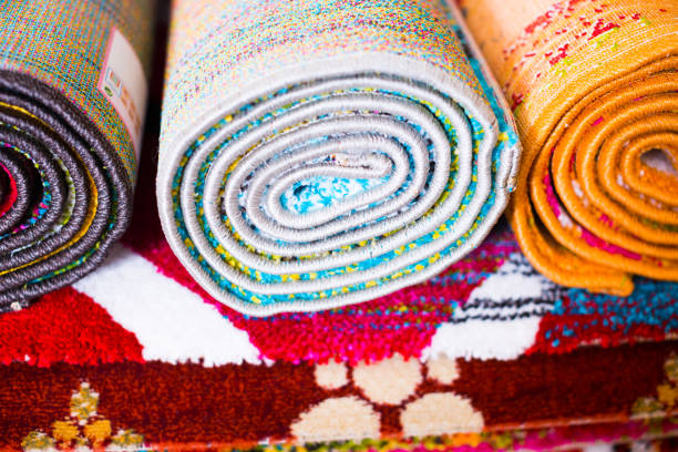 istock Stack of traditional  colorful carpets in carpet shop 1151244928