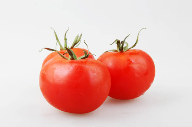istock Close-Up Of Red Tomato On White Background 1151245946