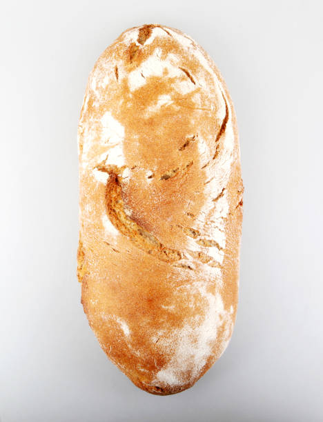 istock Freshly Baked Bread Against White Background 1151247276