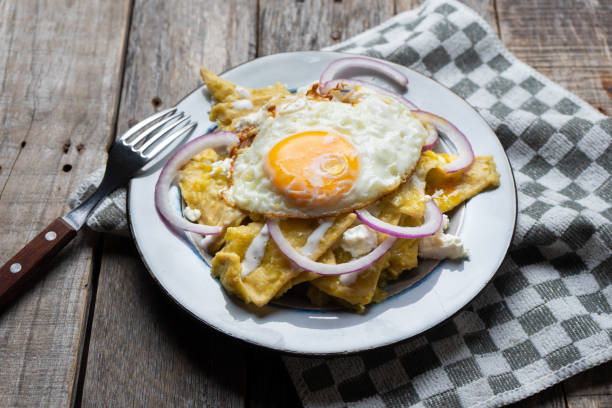 istock Mexican food: tasty green chilaquiles with fried egg, onion and fresh cheese 1151248462