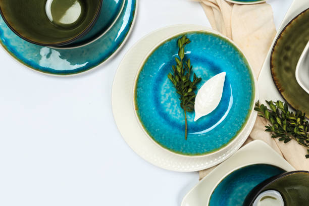 istock Simple rustic handmade blue crockery against white wooden wall: dish, stack of bowls. 1151252683