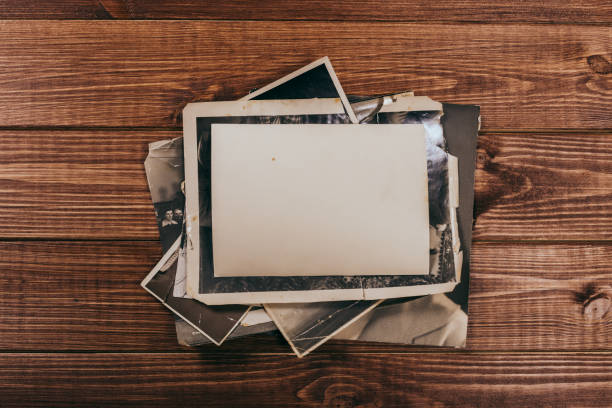 istock Stack old photos on table. Mock-up blank paper. Postcard rumpled and dirty vintage. Retro card 1151252687