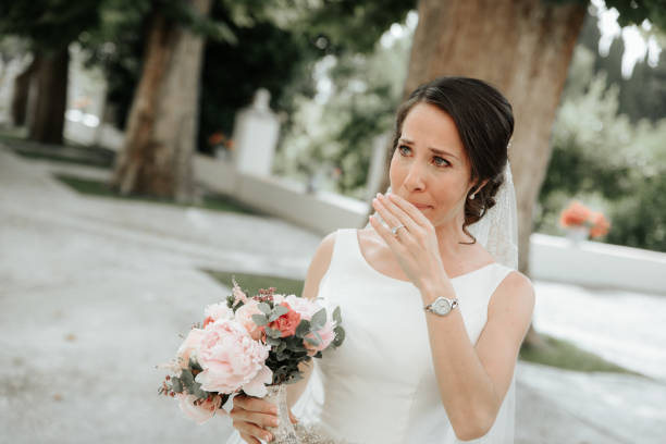 istock Beautiful gorgeous brunet bride crying at the wedding day. 1151253819