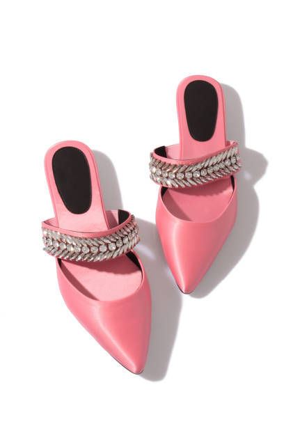 istock Trendy satin pink crystal embellished mules isolated on white, harsh light 1151253958