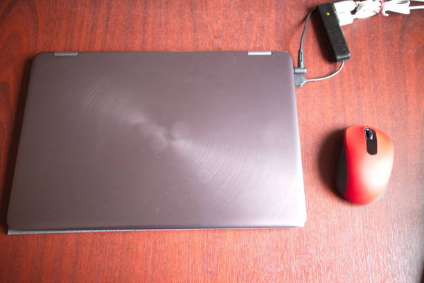 istock laptop and mouse on a dark office desk 1151255301