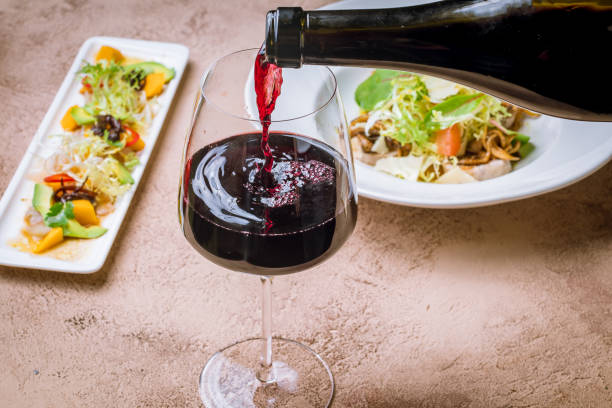 istock red wine pouring into wine glass 1151255315
