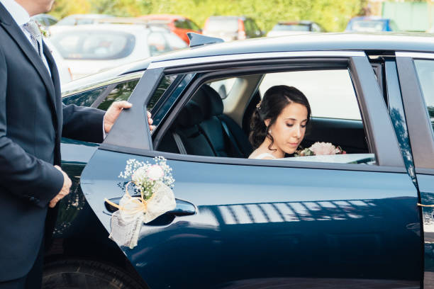 istock Dad opens the car door for the bride. 1151255727
