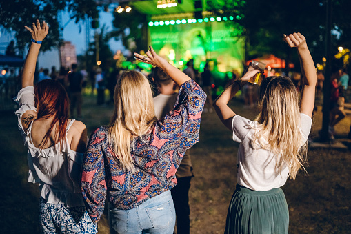 Group of four friends having fun on a music festival
