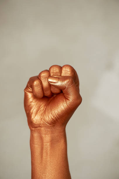 istock Golden fist, on a light background.Gesture of force and aggression 1151258726
