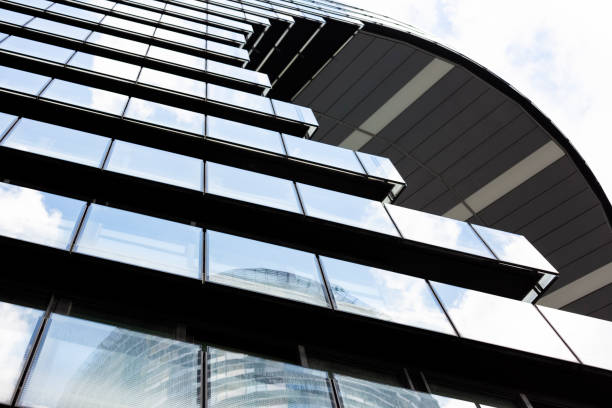 istock Low angle view of modern apartment building, white background with copy space 1151262033