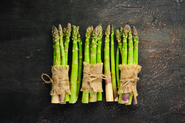 istock Asparagus on a brown background. Green asparagus. Top view. Free space for your text. 1151269998