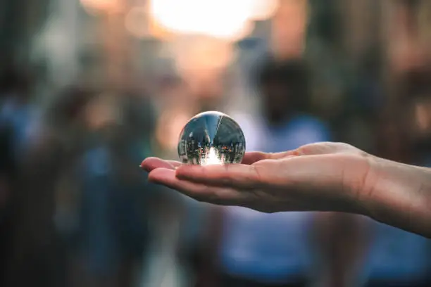 lensball on hand in the streets of the city.