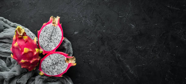 Fresh Pytahya on a black background. Dragon Fruit. Tropical Fruits. Top view. Free space for text. Fresh Pytahya on a black background. Dragon Fruit. Tropical Fruits. Top view. Free space for text. pitaya photos stock pictures, royalty-free photos & images