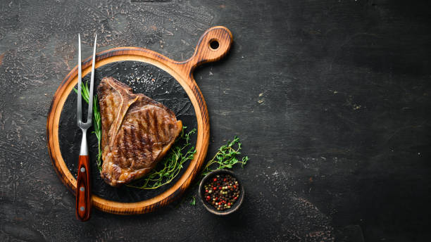 grilled t-bone steak on the old table. top view. free space for text. - beef meat t bone steak steak imagens e fotografias de stock