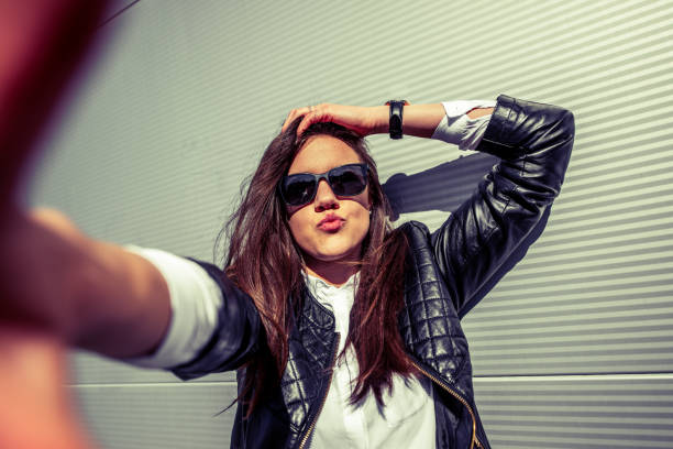 Young Woman Puckering and Taking a Selfie.