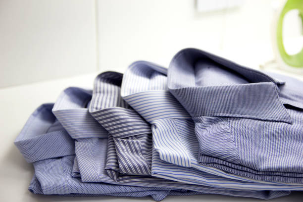istock Clean man shirts folded. Business man clothes. Selective focus. 1151276371