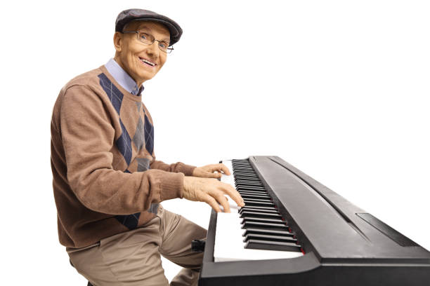 istock Cheerful senior man playing a digital keyboard piano 1151277352
