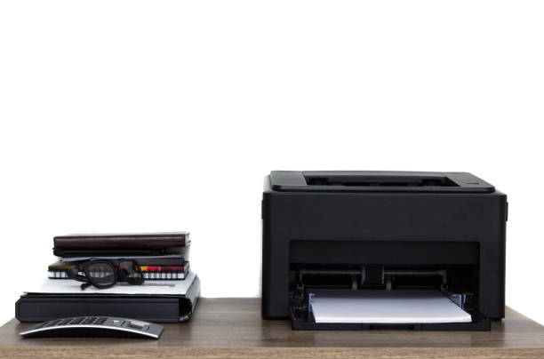 istock Laser printer and office supplies on the table. 1151277773