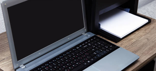 istock Laser printer and laptop on the table. 1151277819