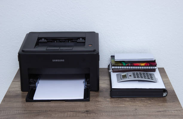 istock Laser printer and office supplies on the table. 1151277952