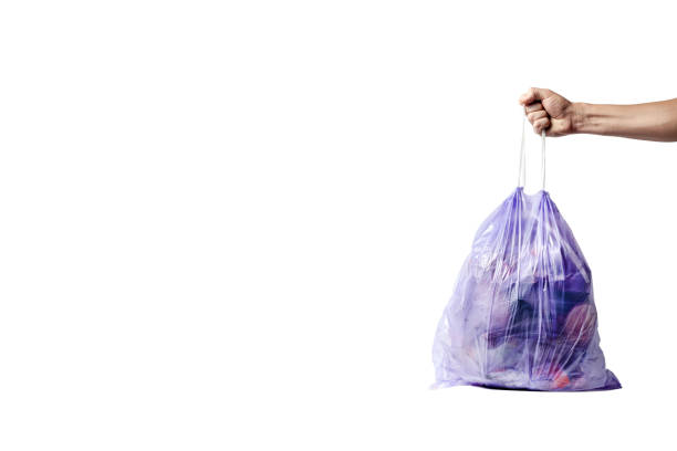 istock mens hand  with full trash bag isolated on white background. garbage collection. waste treatment. environmental Protection. 1151279249