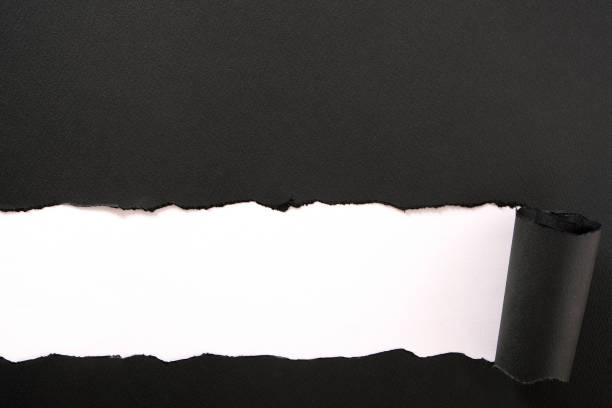 istock Torn black paper strip white background straight 1151283965