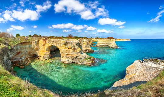 Picturesque seascape with cliffs, rocky arch at Torre Sant Andrea, Salento coast, Puglia region, Italy