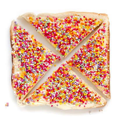 Fairy bread, top view, isolated on white.  Australian children's party food, with colourful sprinkles.