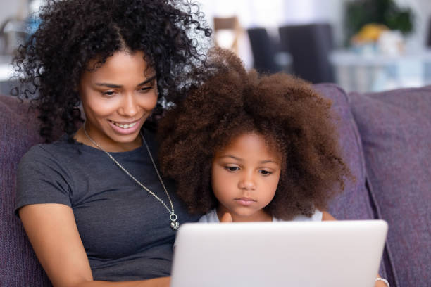 istock African American mom and daughter relax using laptop together 1151286626