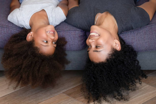 happy african american mom and kid lying upside down - family african ethnicity black african descent imagens e fotografias de stock