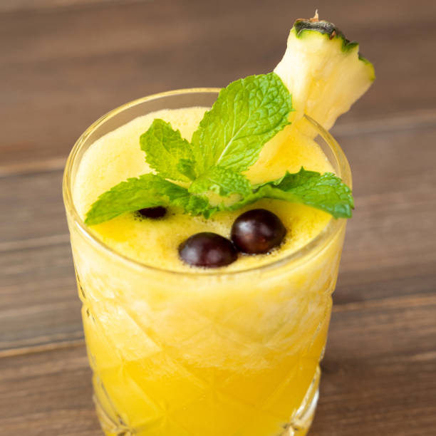 istock Refreshing pineapple summer drink on wooden table 1151287642