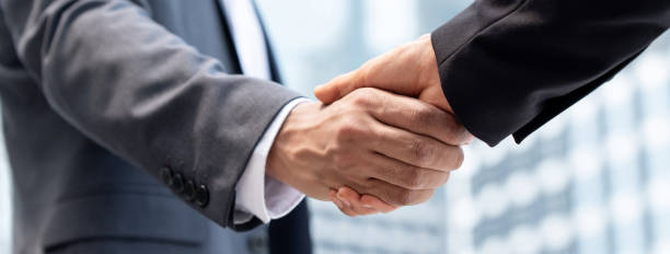 istock Businessmen making handshake in the city 1151287646