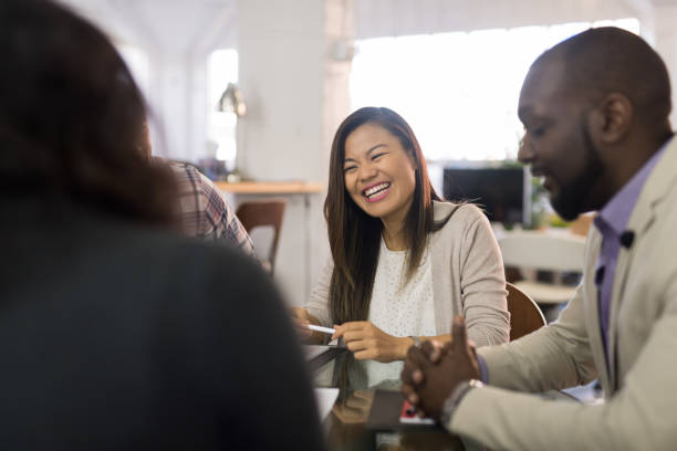 istock Asian American woman working in an open office setting 1151287736