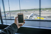 Mobile phone in front of plane