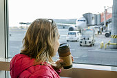 Woman drinking coffee at airport