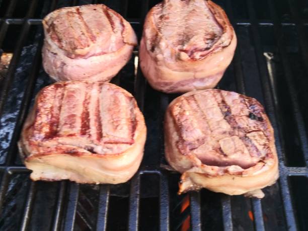 istock Bacon wrapped sirlion steak - cooking on hot grilled 1151293226