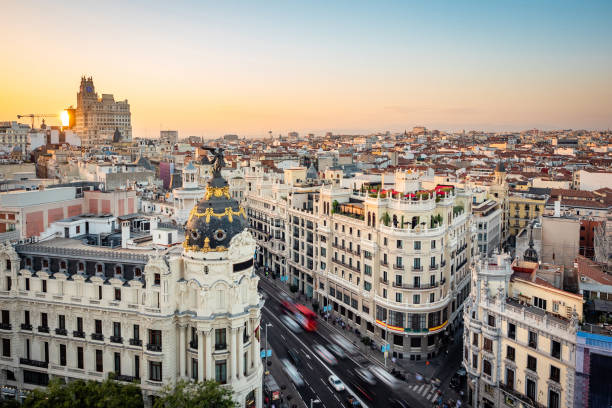 Madrid, Spain, Sunset Over Madrid Cityscape Showing Landmark Buildings on Gran Via Street Sunset over Madrid showing Gran Via street at landmark buildings in Central Madrid, the capital and largest city in Spain. madrid photos stock pictures, royalty-free photos & images