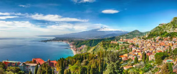 Aquamarine blue waters of  sea near Taormina resorts and Etna volcano mount. Giardini-Naxos bay, Ionian sea coast, Taormina, Sicily, Italy.