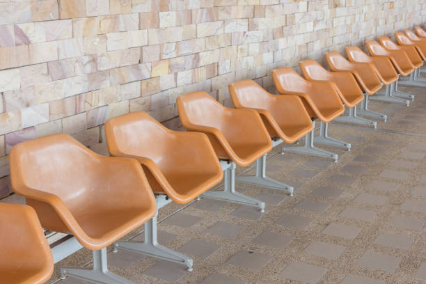 istock Row of empty seats with stone wall 1151301113