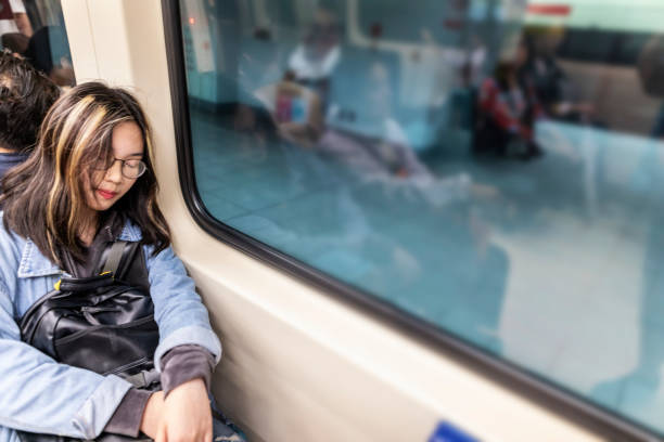 istock Sleeping Asian Woman on a Commuter Train 1151301371