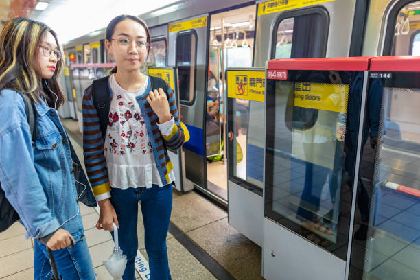 istock Young Asian Women Waiting for a Commuter Train 1151301379