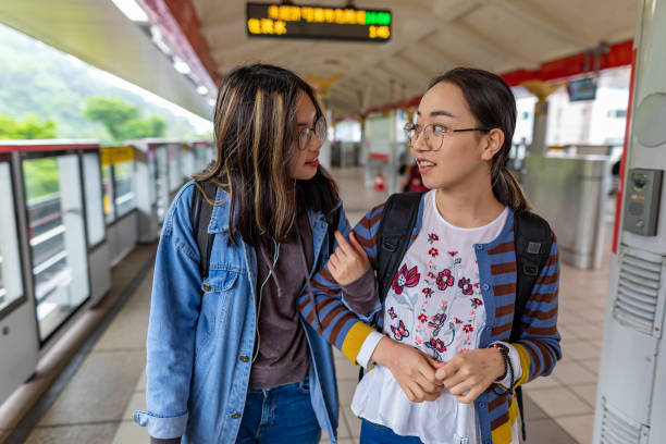 istock Young Asian Women Waiting for a Commuter Train 1151301383