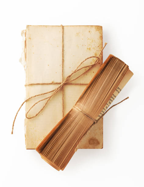 istock Old book paper and book roll with brown string tied 1151304367