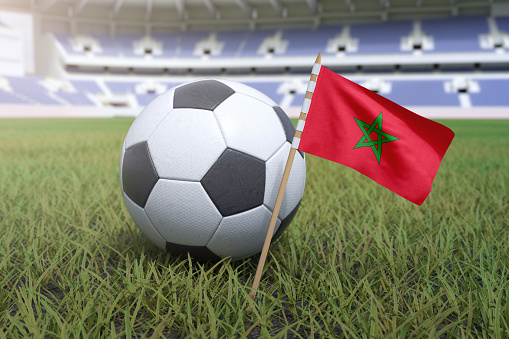 Morocco flag in stadium field with soccer football