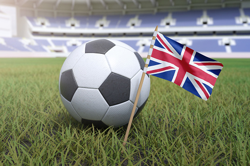 United Kingdom flag in stadium field with soccer football