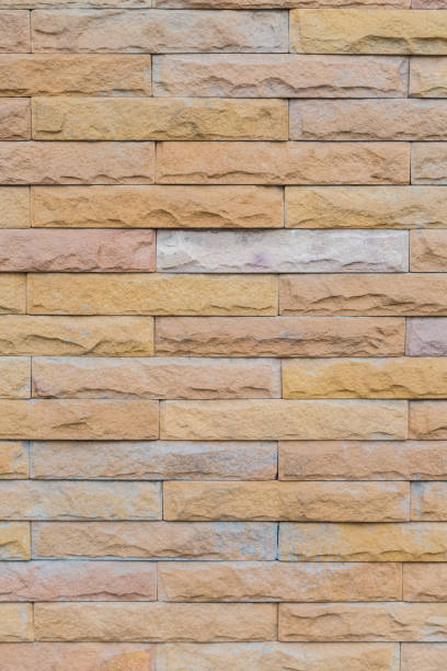 istock yellow stone wall  made with stone blocks 1151312196