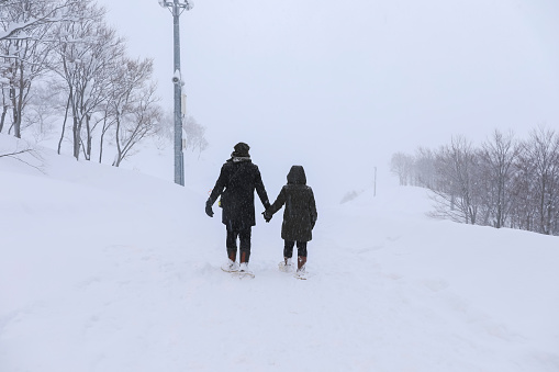 couple lover walking hand in hand on the snow ,Gala Yuzawa/Japan